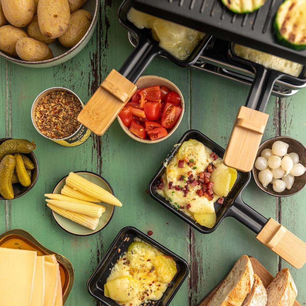 Raclette Zutaten mit Käse Kartoffeln und Beilagen
